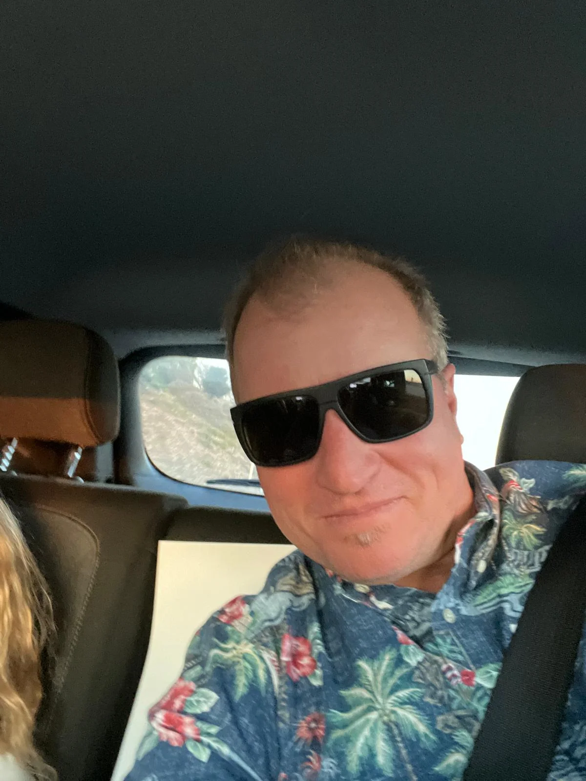 Team member in vehicle during roofing project site visit